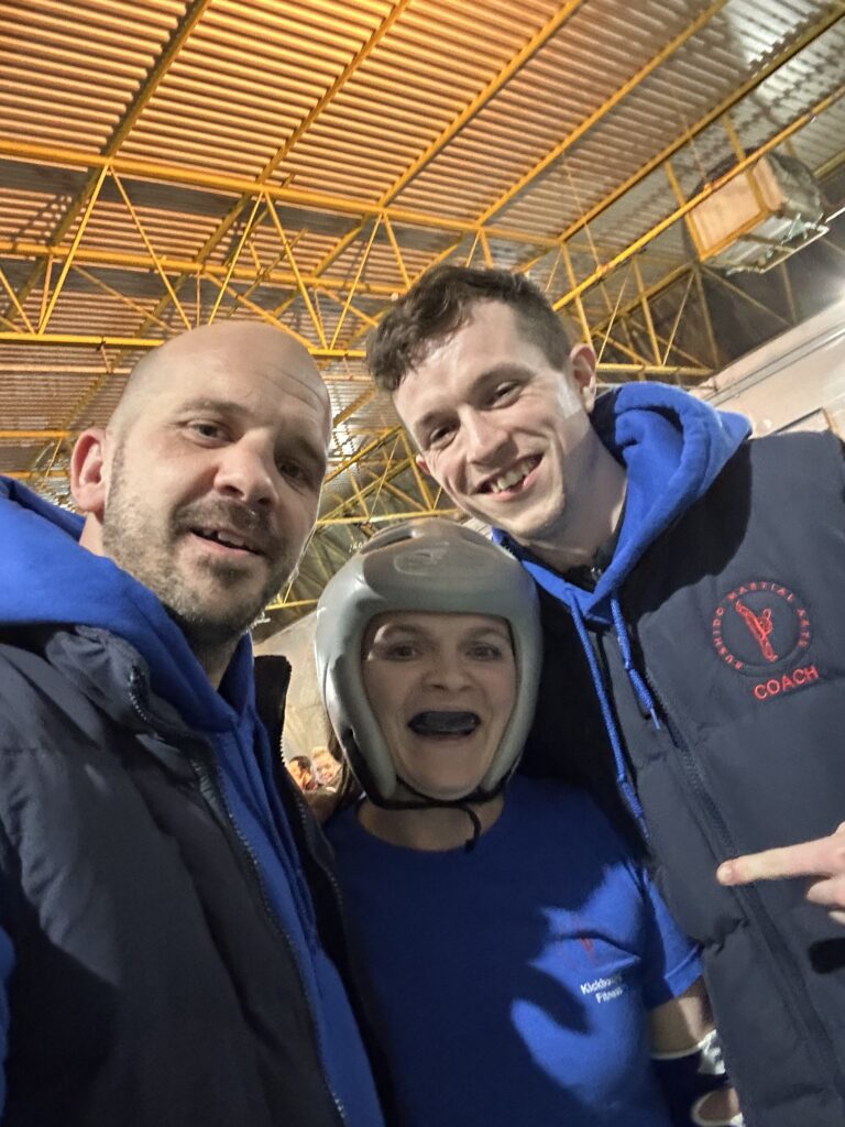 Coaches Ilija Salerno and Robert Barrett along with an enthusiastic Ciara O'Brien after her win.